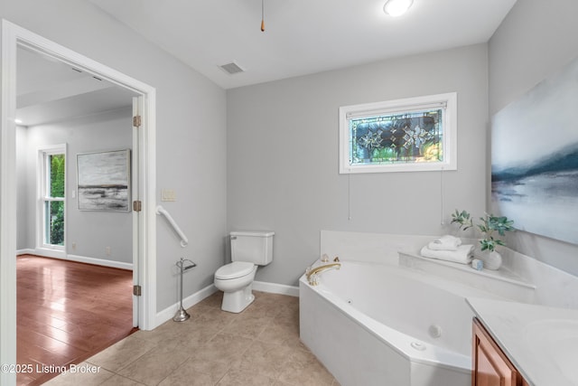 10304 Spring Meyer Rd, Louisville, KY 40223 - bathroom featuring a tub with jets, toilet, baseboards, and vanity