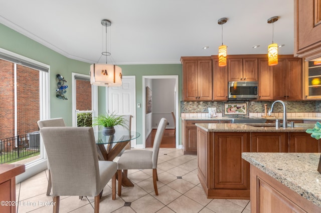 10304 Spring Meyer Rd, Louisville, KY 40223 - kitchen with stainless steel microwave, a sink, brown cabinetry, tasteful backsplash, and ornamental molding