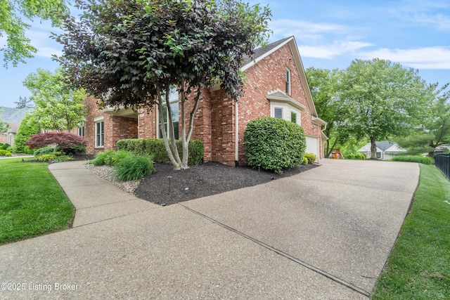 10304 Spring Meyer Rd, Louisville, KY 40223 - view of property exterior featuring brick siding, driveway, a lawn, and an attached garage