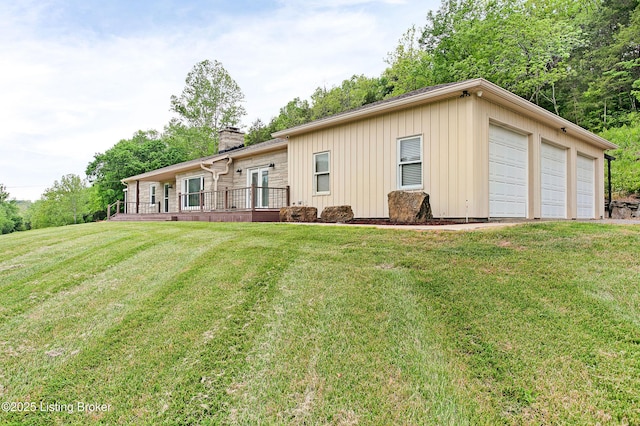 198 Mill Creek Ln, Bardstown, KY 40004 - rear view of property with a chimney, a garage, and a lawn