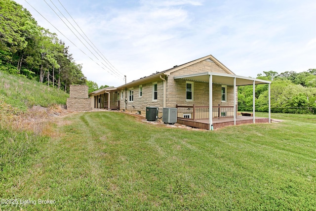 198 Mill Creek Ln, Bardstown, KY 40004 - back of house with stone siding, central air condition unit, and a yard