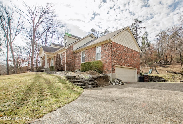 562 Peaceful Way, Shepherdsville, KY 40165 - view of side of property with an attached garage, concrete driveway, brick siding, and a lawn
