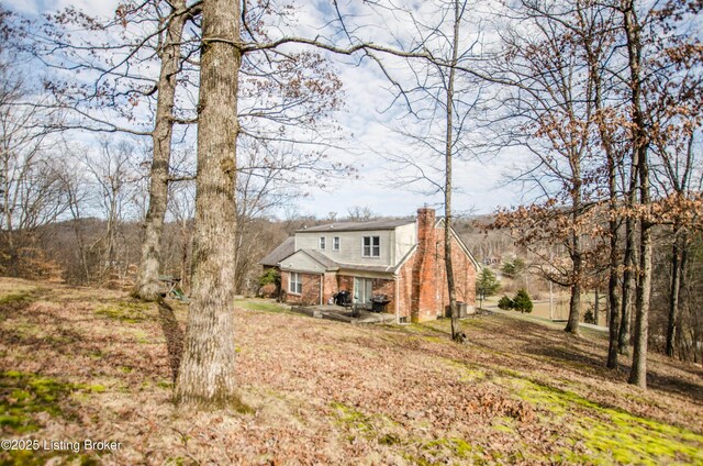 562 Peaceful Way, Shepherdsville, KY 40165 - view of front of house featuring a chimney, covered porch, and brick siding