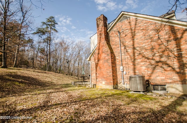 562 Peaceful Way, Shepherdsville, KY 40165 - view of side of property with brick siding, a chimney, and central AC