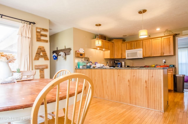562 Peaceful Way, Shepherdsville, KY 40165 - kitchen with white microwave, a peninsula, light wood-style floors, hanging light fixtures, and recessed lighting