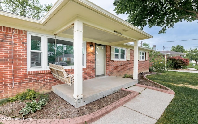 3009 Huberta Dr, Louisville, KY 40216 - entrance to property with brick siding, a porch, and a lawn