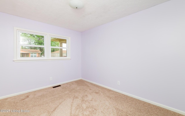 3009 Huberta Dr, Louisville, KY 40216 - carpeted empty room with baseboards and a textured ceiling