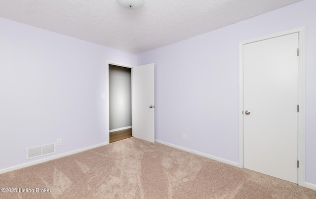 3009 Huberta Dr, Louisville, KY 40216 - carpeted empty room featuring baseboards and a textured ceiling