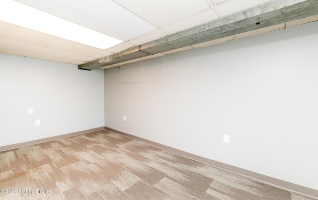 3009 Huberta Dr, Louisville, KY 40216 - finished below grade area featuring baseboards, light colored carpet, and a paneled ceiling