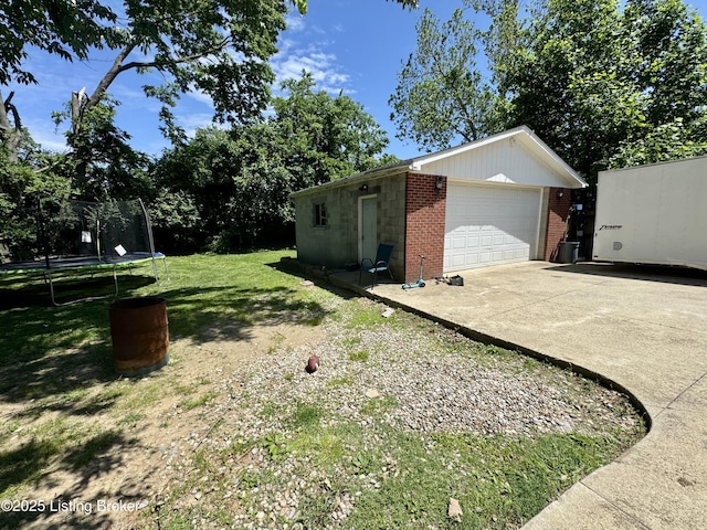 4919 Ferrer Way, Louisville, KY 40291 - view of green lawn with a trampoline, an outdoor structure, concrete driveway, and a garage