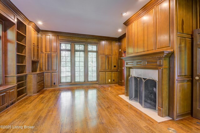 5302 Olde Creek Way, Prospect, KY 40059 - unfurnished living room with light wood finished floors, a fireplace with flush hearth, and crown molding