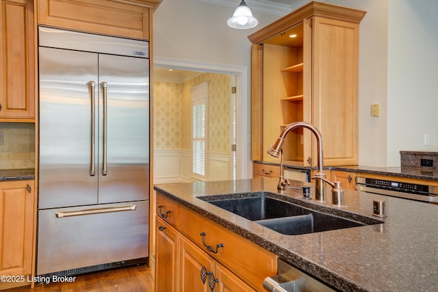 5302 Olde Creek Way, Prospect, KY 40059 - kitchen featuring built in fridge, a sink, crown molding, wainscoting, and dark stone countertops