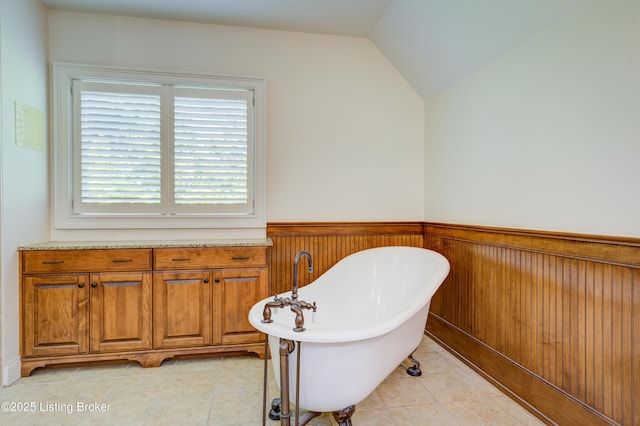 5302 Olde Creek Way, Prospect, KY 40059 - full bathroom featuring a freestanding tub, a wainscoted wall, lofted ceiling, tile patterned floors, and wooden walls