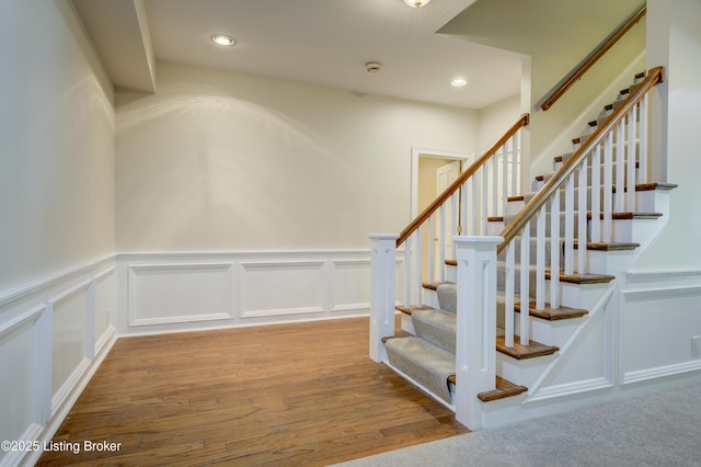 5302 Olde Creek Way, Prospect, KY 40059 - stairs featuring wood finished floors, wainscoting, a decorative wall, and recessed lighting