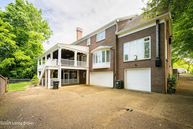 5302 Olde Creek Way, Prospect, KY 40059 - rear view of property with a chimney, fence, brick siding, and a garage