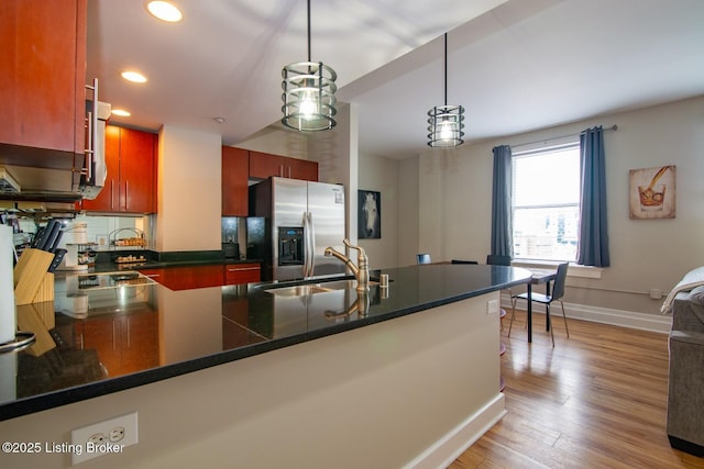 604 S 3rd St Unit 803, Louisville, KY 40202 - kitchen with stainless steel refrigerator with ice dispenser, dark countertops, a sink, a peninsula, and recessed lighting