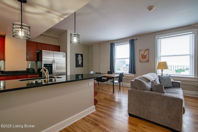 604 S 3rd St Unit 803, Louisville, KY 40202 - kitchen featuring a sink, stainless steel fridge, dark countertops, and light wood-type flooring