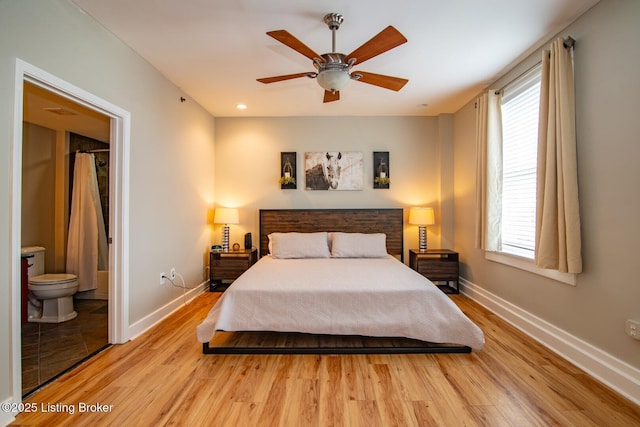 604 S 3rd St Unit 803, Louisville, KY 40202 - bedroom featuring light wood-style floors, baseboards, multiple windows, and ensuite bath