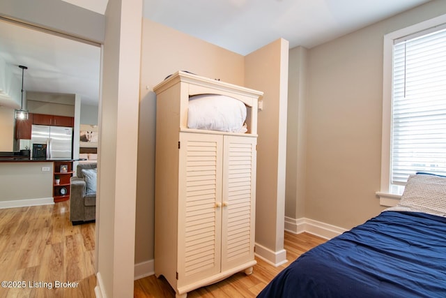 604 S 3rd St Unit 803, Louisville, KY 40202 - bedroom with stainless steel fridge, light wood-type flooring, and baseboards