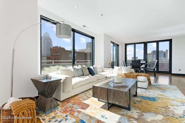 711 W Main St Unit T, Louisville, KY 40202 - living area with a view of skyline, wood finished floors, and recessed lighting