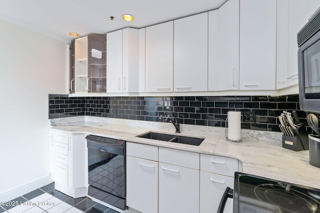 711 W Main St Unit T, Louisville, KY 40202 - kitchen with black appliances, a sink, light stone countertops, white cabinetry, and decorative backsplash