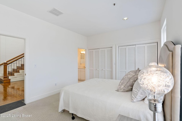 711 W Main St Unit T, Louisville, KY 40202 - bedroom with carpet, two closets, baseboards, and connected bathroom
