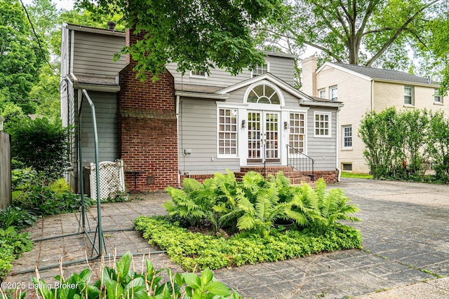 3920 Elfin Ave, Louisville, KY 40207 - back of property with french doors, entry steps, driveway, and crawl space