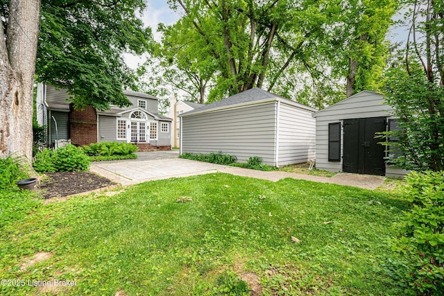 3920 Elfin Ave, Louisville, KY 40207 - view of green lawn with an outdoor structure, french doors, and a patio area