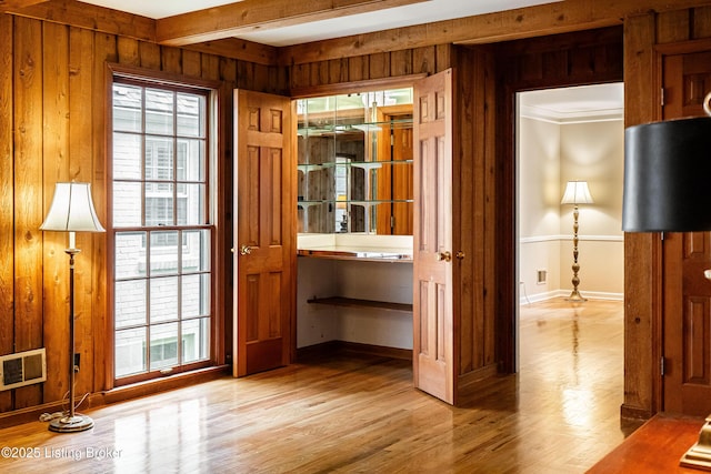 3920 Elfin Ave, Louisville, KY 40207 - doorway featuring wooden walls, baseboards, and light wood finished floors