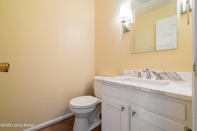 3920 Elfin Ave, Louisville, KY 40207 - bathroom featuring vanity, toilet, wood finished floors, and baseboards