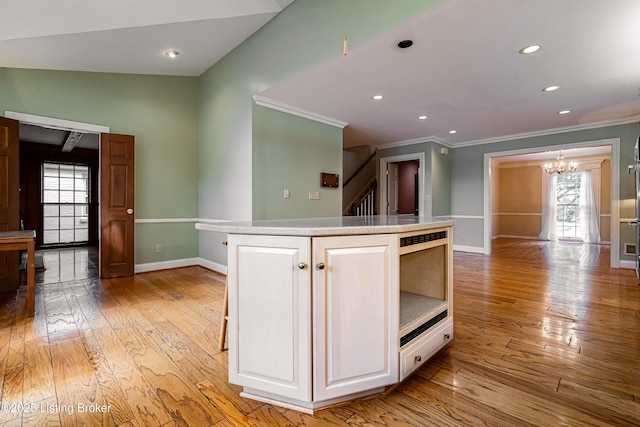 3920 Elfin Ave, Louisville, KY 40207 - kitchen featuring ornamental molding, a chandelier, light wood-style flooring, baseboards, and white cabinets