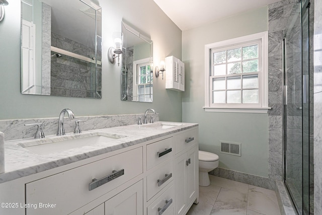 3920 Elfin Ave, Louisville, KY 40207 - bathroom with marble finish flooring, double vanity, toilet, and a stall shower
