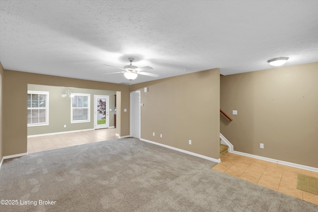 8712 Chetwood Trace Dr, Louisville, KY 40291 - tiled empty room featuring ceiling fan, carpet floors, baseboards, a textured ceiling, and stairway