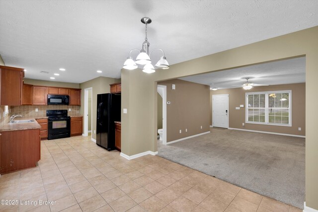 8712 Chetwood Trace Dr, Louisville, KY 40291 - kitchen with black appliances, a sink, light carpet, a chandelier, and open floor plan