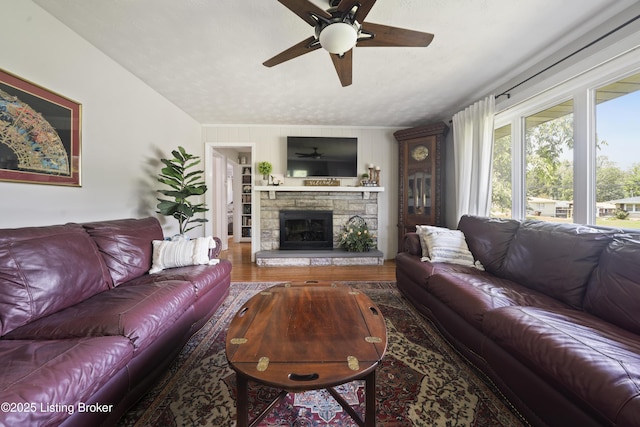 5506 Bamberrie Cross Rd, Louisville, KY 40214 - living room featuring a ceiling fan, a fireplace, wood finished floors, and a textured ceiling