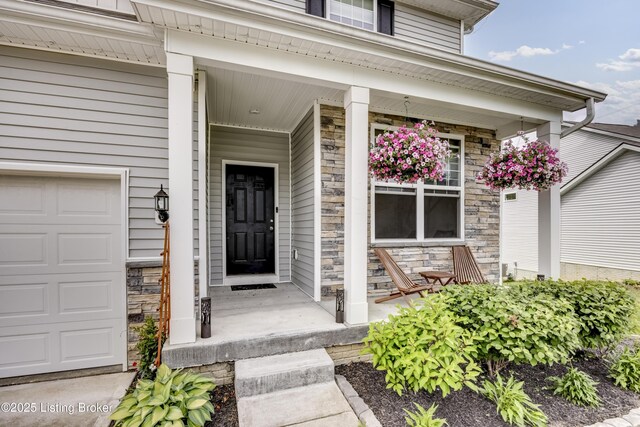 3928 Creek Meadow Dr, La Grange, KY 40031 - view of exterior entry with covered porch, stone siding, and a garage