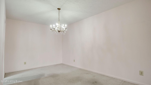 3030 Breckenridge Ln Unit 108, Louisville, KY 40220 - spare room featuring a chandelier, light colored carpet, and baseboards