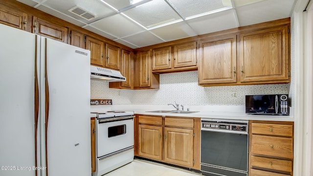 3030 Breckenridge Ln Unit 108, Louisville, KY 40220 - kitchen featuring black appliances, a sink, under cabinet range hood, light countertops, and brown cabinetry