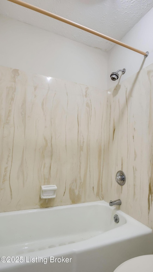 3030 Breckenridge Ln Unit 108, Louisville, KY 40220 - bathroom featuring bathing tub / shower combination, toilet, and a textured ceiling