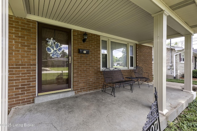 7407 Beahl Blvd, Louisville, KY 40258 - doorway to property with covered porch and brick siding
