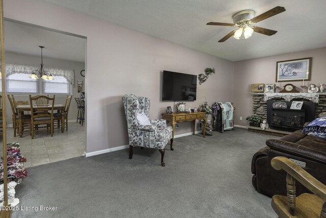 7407 Beahl Blvd, Louisville, KY 40258 - carpeted living area featuring a ceiling fan, a chandelier, baseboards, and a stone fireplace