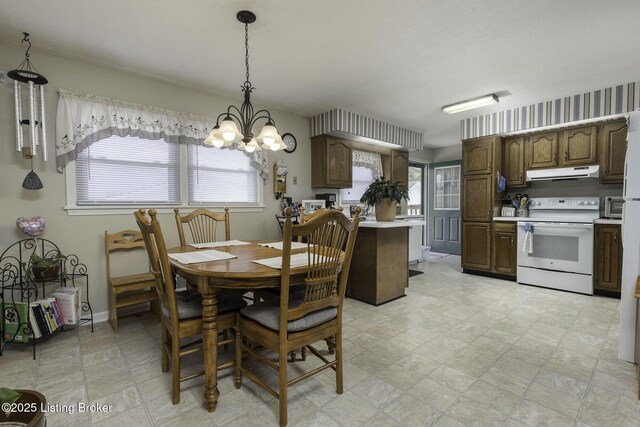7407 Beahl Blvd, Louisville, KY 40258 - dining area featuring a chandelier, plenty of natural light, and baseboards