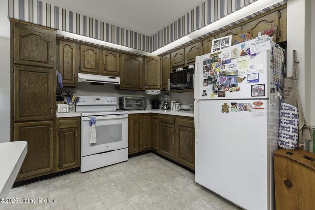 7407 Beahl Blvd, Louisville, KY 40258 - kitchen with white appliances, under cabinet range hood, light countertops, light floors, and wallpapered walls