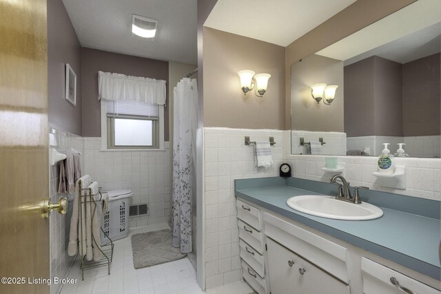 7407 Beahl Blvd, Louisville, KY 40258 - full bath with tile walls, vanity, tile patterned floors, wainscoting, and a shower with shower curtain