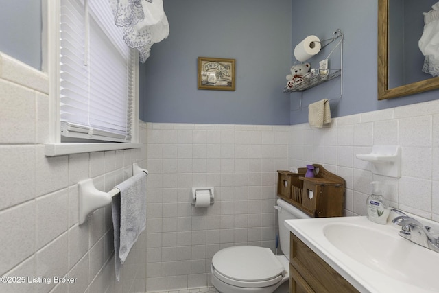 7407 Beahl Blvd, Louisville, KY 40258 - bathroom featuring tile walls, toilet, vanity, and wainscoting