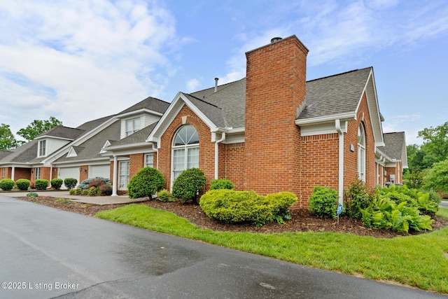 10431 Monticello Forest Cir, Jeffersontown, KY 40299 - view of front facade with brick siding, roof with shingles, a garage, and a chimney