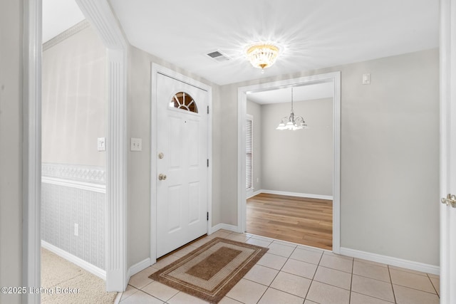 10431 Monticello Forest Cir, Jeffersontown, KY 40299 - entryway featuring a chandelier, tile patterned flooring, and baseboards