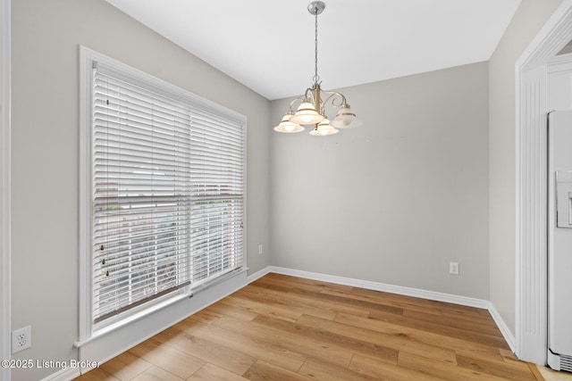 10431 Monticello Forest Cir, Jeffersontown, KY 40299 - spare room with a chandelier, light wood finished floors, and baseboards