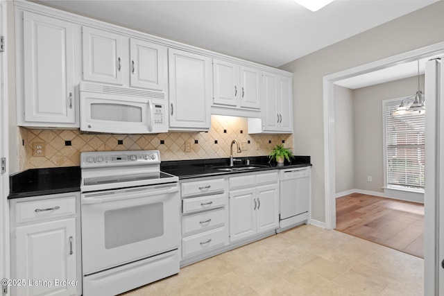 10431 Monticello Forest Cir, Jeffersontown, KY 40299 - kitchen featuring white appliances, dark countertops, a sink, and white cabinetry