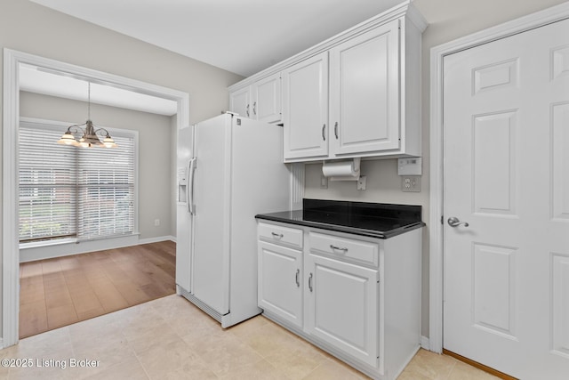 10431 Monticello Forest Cir, Jeffersontown, KY 40299 - kitchen featuring dark countertops, a chandelier, white cabinets, hanging light fixtures, and white fridge with ice dispenser